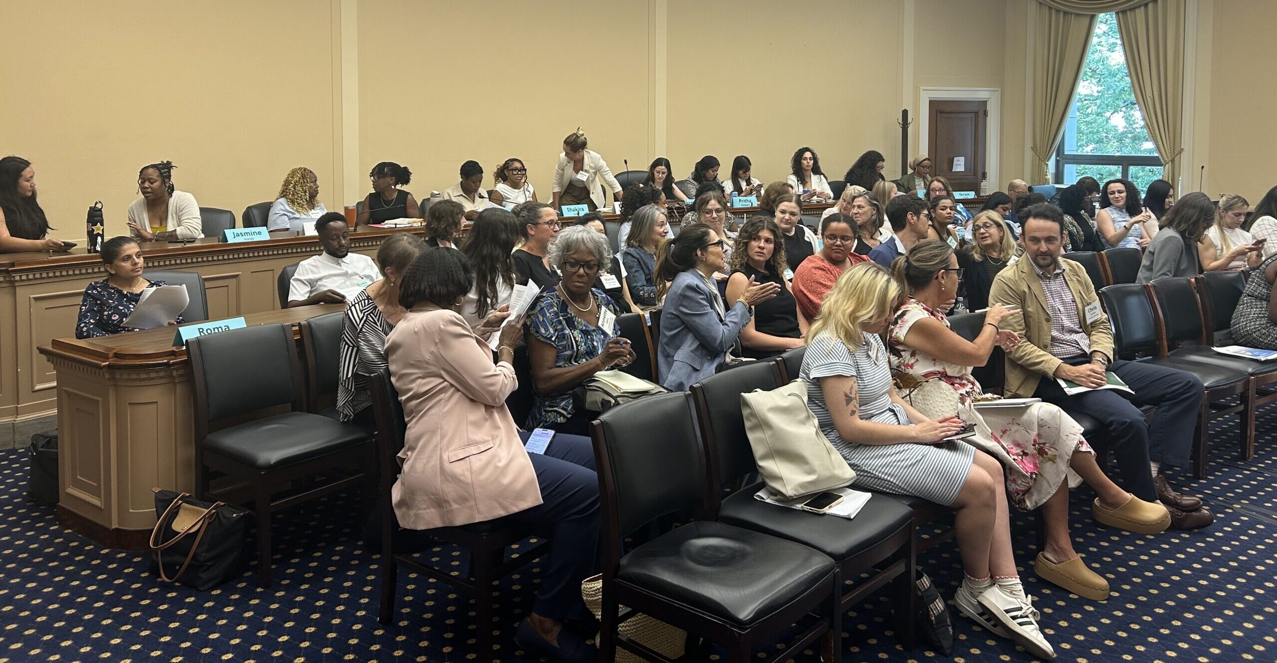 Students and faculty chat amongst themself in a c.onference room